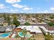 A high angle shows a house in a residential neighborhood with a boat, pool, carport, and mature trees at 1308 S Spur --, Mesa, AZ 85204