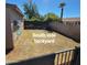 South side of the backyard featuring a yard with space for activities and a view of the fence at 1308 S Spur --, Mesa, AZ 85204