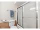 Bathroom features a toilet and a shower with sliding glass doors at 1308 S Spur --, Mesa, AZ 85204