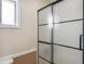 This bathroom features a glass enclosed shower with black trim and a window that allows for natural light at 1308 S Spur --, Mesa, AZ 85204
