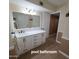 Bright bathroom with a long vanity, offering ample storage, complemented by modern fixtures and finishes at 1308 S Spur --, Mesa, AZ 85204