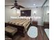 Bedroom boasts a ceiling fan, sconce lighting, and mirrored closet at 1308 S Spur --, Mesa, AZ 85204