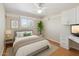 Bright bedroom with a large window, built-in shelves and a ceiling fan at 1308 S Spur --, Mesa, AZ 85204