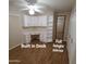 Bedroom 2 with ceiling fan, wood floors, built in desk and shelving and full-length mirror at 1308 S Spur --, Mesa, AZ 85204