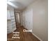 Bedroom 2 with wood floors, closet and built in shelving and full-length mirror at 1308 S Spur --, Mesa, AZ 85204