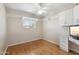 Bedroom features hardwood flooring, fan, and a built in desk area at 1308 S Spur --, Mesa, AZ 85204