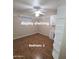 Bedroom 2 with ceiling fan and wood floors and built in shelves at 1308 S Spur --, Mesa, AZ 85204