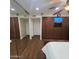 Bedroom featuring hardwood floors, large cabinets with entertainment system, and mirrored closet at 1308 S Spur --, Mesa, AZ 85204