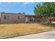 Home exterior featuring a simple desert-style front yard with mature trees and a covered entry at 1308 S Spur --, Mesa, AZ 85204