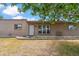 Exterior front facade features a well-manicured garden bed, security door, and a quaint front porch seating at 1308 S Spur --, Mesa, AZ 85204