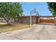 Exterior front facade includes a shade tree, well-maintained lawn, a convenient carport, and desert landscaping at 1308 S Spur --, Mesa, AZ 85204