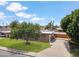 Charming home with mature trees, a well-kept lawn, and convenient carport at 1308 S Spur --, Mesa, AZ 85204