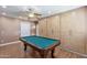This expansive game room features a pool table, wood-look flooring, a ceiling fan, and lots of storage space at 1308 S Spur --, Mesa, AZ 85204