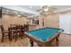 This spacious game room has wood-look flooring, a pool table, ceiling fans, and a dining table at 1308 S Spur --, Mesa, AZ 85204