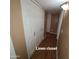 Hallway featuring a linen closet on wood-look vinyl flooring at 1308 S Spur --, Mesa, AZ 85204