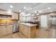 Open kitchen and dining area with stainless steel appliances, tile floors, and pool table in the background at 1308 S Spur --, Mesa, AZ 85204