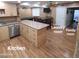 Open kitchen with a large island, modern appliances, and a view into the living spaces at 1308 S Spur --, Mesa, AZ 85204
