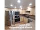 New stainless steel microwave, oven, dishwasher, sink and faucet in the modern kitchen at 1308 S Spur --, Mesa, AZ 85204