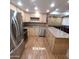 Spacious kitchen featuring stainless steel appliances, ample cabinet space, and tile floors at 1308 S Spur --, Mesa, AZ 85204