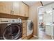 This laundry room features matching front load washer and dryer with abundant cabinet space above at 1308 S Spur --, Mesa, AZ 85204