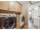 Functional laundry room with cabinets, tile floors, washer, and dryer, plus access to the bathroom, convenient for chores at 1308 S Spur --, Mesa, AZ 85204