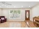 Inviting living room with lots of natural light and hardwood flooring, features a quaint chair and decorative piano at 1308 S Spur --, Mesa, AZ 85204