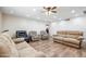 This living room boasts wood-look flooring, plush seating, and plenty of natural light at 1308 S Spur --, Mesa, AZ 85204