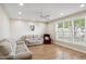 Bright living room with hardwood floors, ceiling fan, large window, and comfortable couches for relaxing and entertaining at 1308 S Spur --, Mesa, AZ 85204
