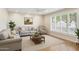 Sunlit living room features neutral decor, hardwood floors, plantation shutters, and comfortable seating at 1308 S Spur --, Mesa, AZ 85204
