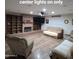 Spacious living room features recessed lighting, a brick fireplace, and built-in shelving at 1308 S Spur --, Mesa, AZ 85204