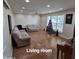 Light filled living room with christmas tree by window and wood look flooring at 1308 S Spur --, Mesa, AZ 85204