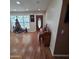 Light filled living room with christmas tree by window and wood look flooring at 1308 S Spur --, Mesa, AZ 85204