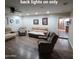 Open-concept living room with wood-look flooring and neutral color scheme with kitchen in background at 1308 S Spur --, Mesa, AZ 85204