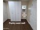 Well-organized pantry with white cabinets, with a convenient AC window unit for climate control at 1308 S Spur --, Mesa, AZ 85204