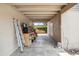 Covered patio with concrete floor, storage, workbench and ladder at 1308 S Spur --, Mesa, AZ 85204