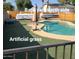 North side of the backyard showcasing artificial grass and an in-ground pool at 1308 S Spur --, Mesa, AZ 85204