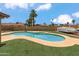 Inviting backyard swimming pool surrounded by artificial turf and a trailer for outdoor fun at 1308 S Spur --, Mesa, AZ 85204