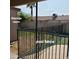 View of the black pool fence next to the storage room that encloses a beautiful in-ground pool at 1308 S Spur --, Mesa, AZ 85204