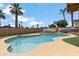 Beautiful in-ground pool with an umbrella, travel trailer, a boat, and lush landscaping for outdoor relaxation at 1308 S Spur --, Mesa, AZ 85204