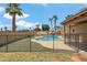 Fenced swimming pool on a manicured lawn with boats and palm trees, perfect for outdoor enjoyment at 1308 S Spur --, Mesa, AZ 85204