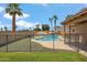 Fenced in in-ground pool surrounded by tropical landscaping and an adjacent boat and trailer at 1308 S Spur --, Mesa, AZ 85204