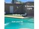 View of the pool with artificial grass and a security light on the back of the house at 1308 S Spur --, Mesa, AZ 85204
