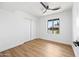 Bright, minimal bedroom with light wood flooring, white walls, and a large window offering an outdoor view at 1444 W Wickieup Ln, Phoenix, AZ 85027