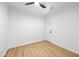 Cozy bedroom featuring neutral walls, wood flooring, and a contemporary ceiling fan at 1444 W Wickieup Ln, Phoenix, AZ 85027