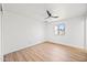 Well-lit bedroom featuring a ceiling fan, window, and hardwood flooring at 1444 W Wickieup Ln, Phoenix, AZ 85027