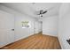 Bright bedroom features a window, hardwood floors and a ceiling fan at 1444 W Wickieup Ln, Phoenix, AZ 85027