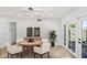Bright dining room with modern lighting, a round table, and doors leading to the patio at 1444 W Wickieup Ln, Phoenix, AZ 85027