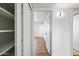 Hallway features an open room and a closet with shelves for storage at 1444 W Wickieup Ln, Phoenix, AZ 85027