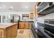Kitchen with stainless appliances, light wood cabinets, a butcher block island and black countertops at 1444 W Wickieup Ln, Phoenix, AZ 85027