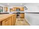 Well-lit kitchen featuring natural wood cabinets, stainless steel oven, and tile floors at 1444 W Wickieup Ln, Phoenix, AZ 85027